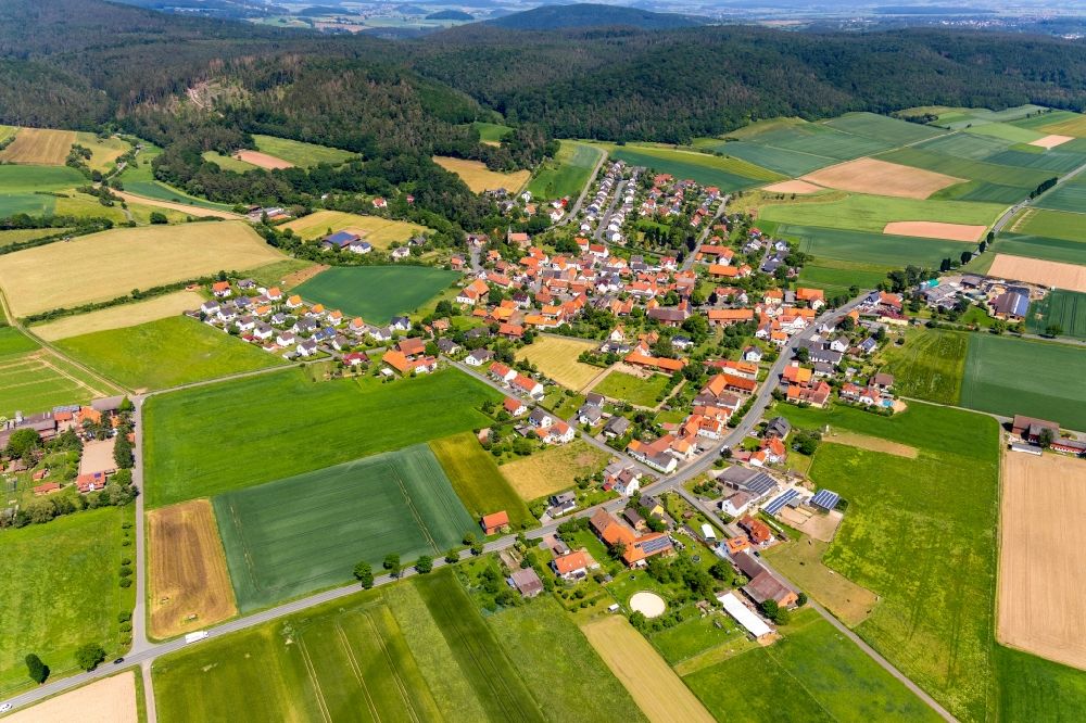 Aerial image Wellen - Agricultural land and field borders surround the settlement area of the village in Wellen in the state Hesse, Germany
