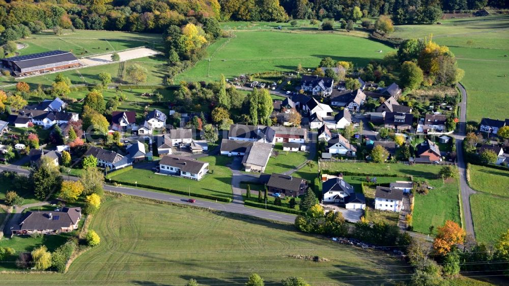 Aerial image Wellesberg - Agricultural land and field borders surround the settlement area of the village in Wellesberg in the state North Rhine-Westphalia, Germany