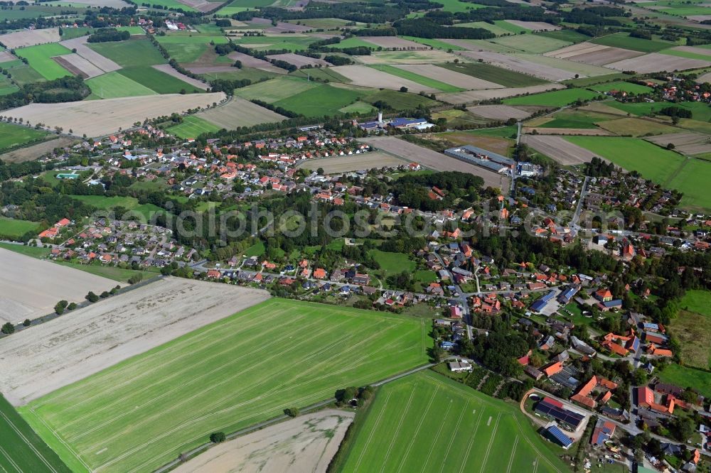 Aerial image Wieren - Agricultural land and field borders surround the settlement area of the village in Wieren in the state Lower Saxony, Germany