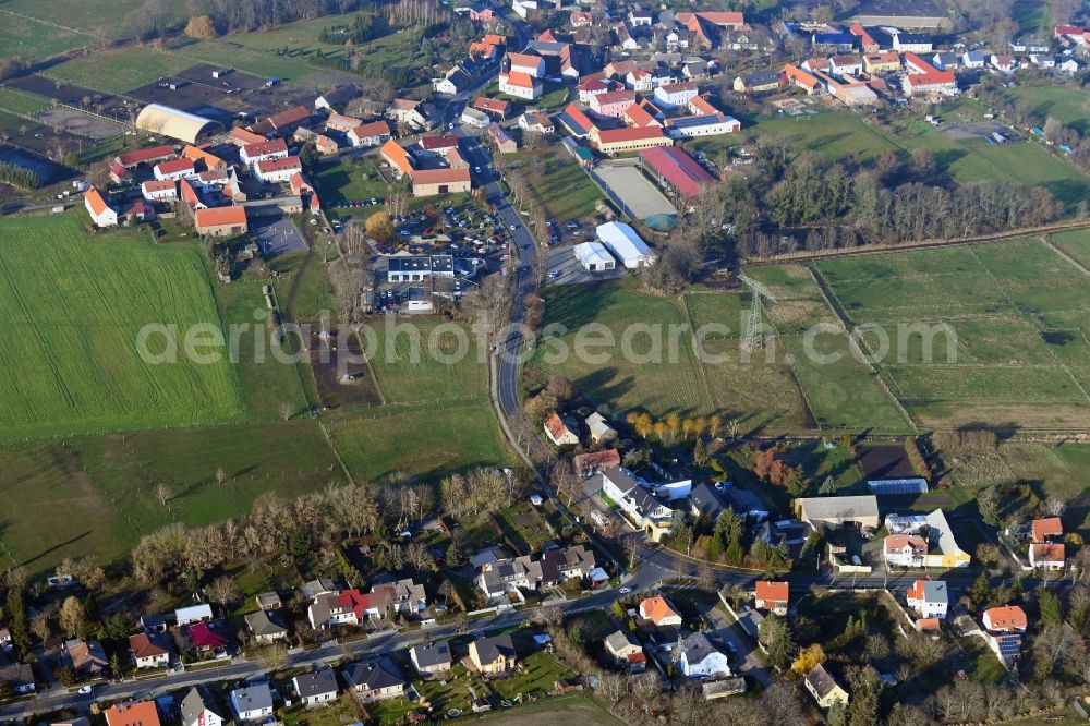 Wietstock from above - Agricultural land and field borders surround the settlement area of the village in Wietstock in the state Brandenburg, Germany