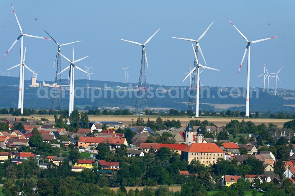 Aerial image Frauenprießnitz - Agricultural areas and field boundaries with wind turbines surround the settlement area of the village in Frauenpriessnitz in the state Thuringia, Germany
