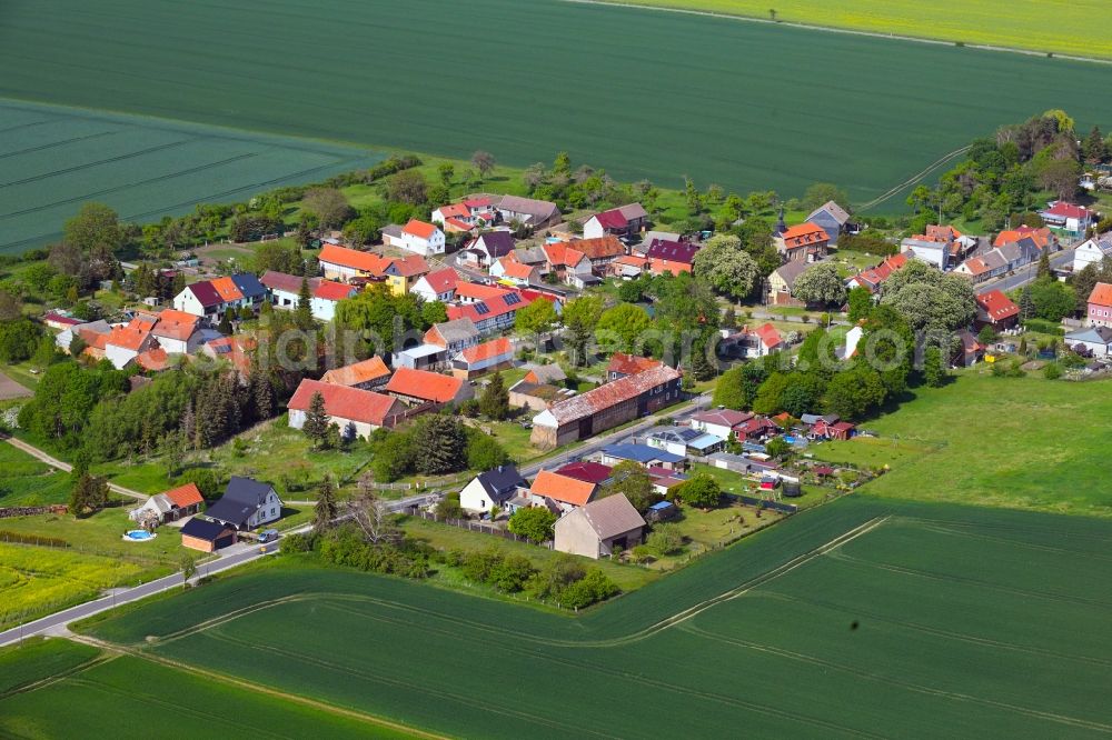Wolferschwenda from above - Agricultural land and field borders surround the settlement area of the village in Wolferschwenda in the state Thuringia, Germany