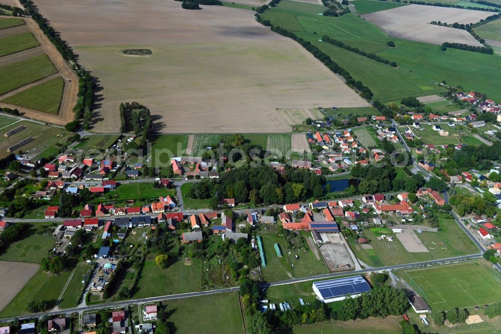 Zaatzke from above - Agricultural land and field borders surround the settlement area of the village in Zaatzke in the state Brandenburg, Germany