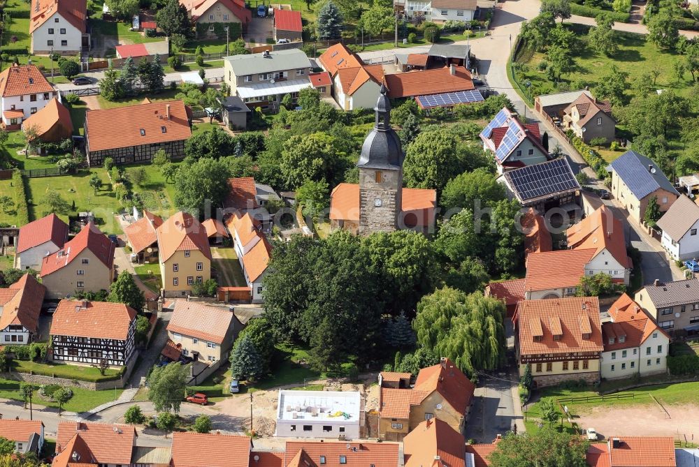 Holzhausen from the bird's eye view: In the village center of Holzhausen in the state of Thuringia is the Holy Trinity Church. The medieval church was later rebuilt in the architectural style of Rococo. The tower was heightened in the early 19th century
