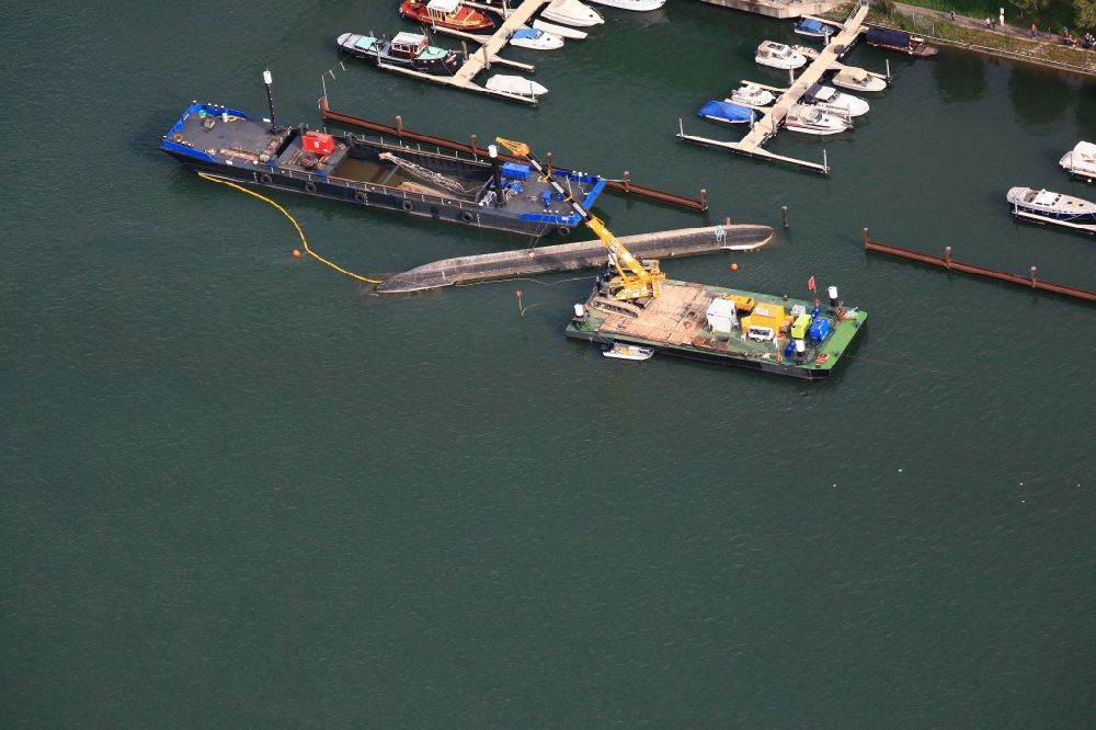Basel from above - At the triangle Germany France Switzerland in Basel, Switzerland, the dredger Merlin is recovered. On 04 August 2014, the ship capsized and has since been upturned and secured at the entrance to the Rhine harbor Kleinhueningen