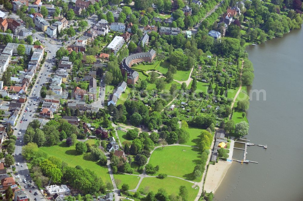Lübeck from the bird's eye view: Draeger Park and residential buildings in the Marli part of St.Gertrud in Luebeck in the state of Schleswig-Holstein. St.Gertrud is the Easternmost historic suburb of Luebeck. Located on the riverbank of the Wakenitz, there are several green areas such as Draegerpark and historic residential buildings. The red, semi-circular building with the adjacent park is especially distinct