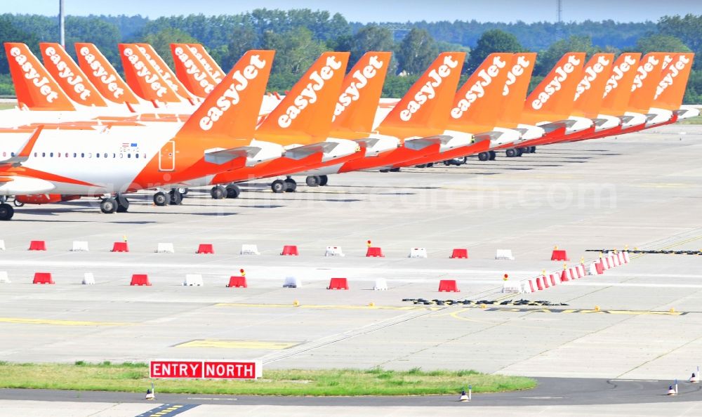 Schönefeld from above - Passenger airplanes of airline easyjet - closed due to crisis - in parking position - parking area at the airport in Schoenefeld in the state Brandenburg, Germany