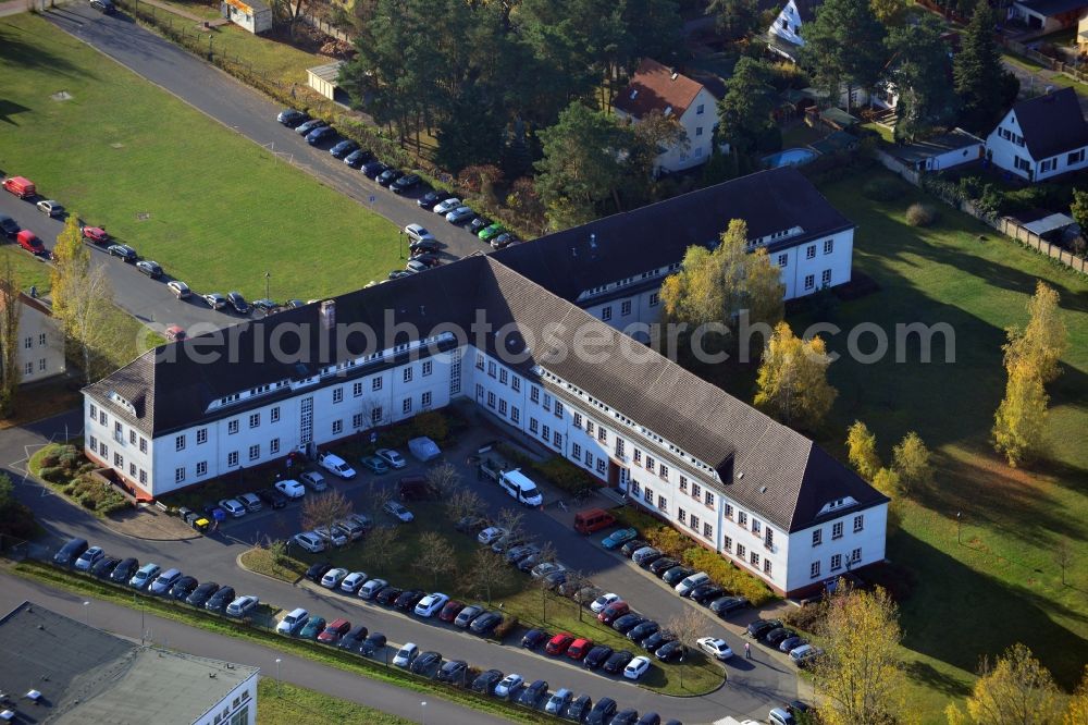 Aerial image Oranienburg - View of the former SS administration building for the Inspectorate of Concentration Camps at Heinrich Gruber Square in Oranienburg in Brandenburg. The T-Building ( named for its shape ) was constructed in 1937-38 by forced labor of concentration camp prisoners and served as headquarters for the leadership of the SS Death's Head Units and the Inspectorate of Concentration Camps. The conditions and the genocide in many concentration camps was bureaucratically planed and coordinated here. Today the premises are location for institutions of the Brandenburg Memorials Foundation and the IRS Oranienburg