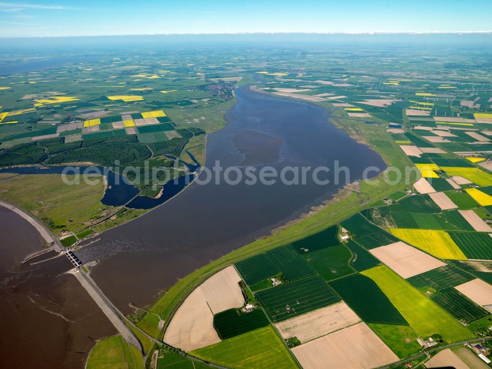 Aerial image Wesselburenerkoog - The Eider flood barrier in Toenning in the state of Schleswig-Holstein. The barrage is located on the mouth of the river Eider, going into the North Sea. The barrier is in place for protection against storm flooding of the North Sea. It was built in 1967, consisting of 2 rows with 5 gates each to provide double flooding protection. The landscape along the riverbank of the Eider consists of agricultural fields