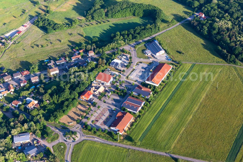 Neulauterburg from the bird's eye view: Buildings of the shopping center Muehlaecker with Netto Filiale, TEDi, PENNY, DEICHMANN and Bau-Solar Suedwest GmbH for the French customers in Neulauterburg in the state Rhineland-Palatinate, Germany