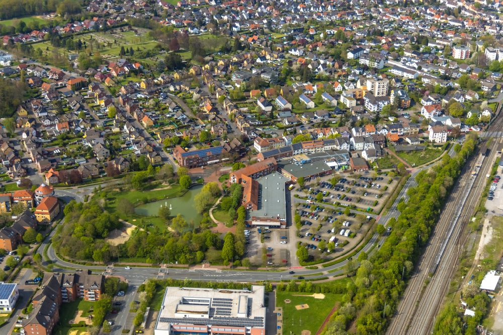 Bönen from above - Building of the shopping center on Bahnhofstrasse with park and community pond in Boenen in the Ruhr area in the state North Rhine-Westphalia, Germany