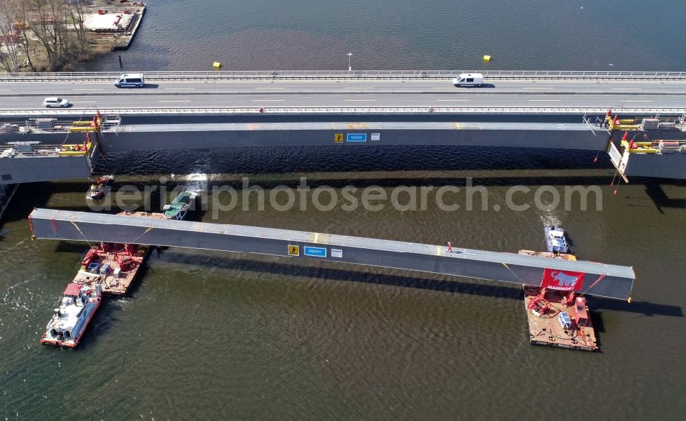 Aerial image Petersdorf - Floating in the last steel segment of the route and lanes in the course of the motorway bridge of the BAB A19 Petersdorfer Bruecke with construction site for a replacement new building in Petersdorf in the state of Mecklenburg-Western Pomerania
