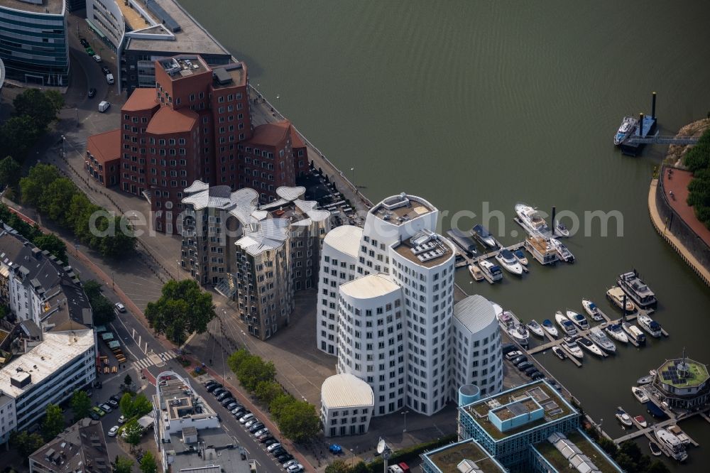 Aerial image Düsseldorf - Office building Neuer Zollhof on Medienhafen on Ufer of Rhein in Duesseldorf at Ruhrgebiet in the state North Rhine-Westphalia, Germany. The Neuer Zollhof is a building ensemble in the Duesseldorf Media Harbor. The buildings are also known as Gehry buildings after their architect and designer Frank Gehry