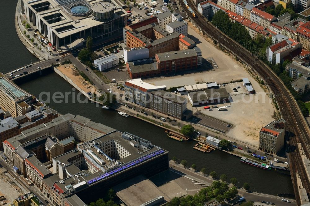 Aerial image Berlin - Developing field of residential and commercial space on Schiffbauerdamm on Spree river in the district Mitte in Berlin, Germany
