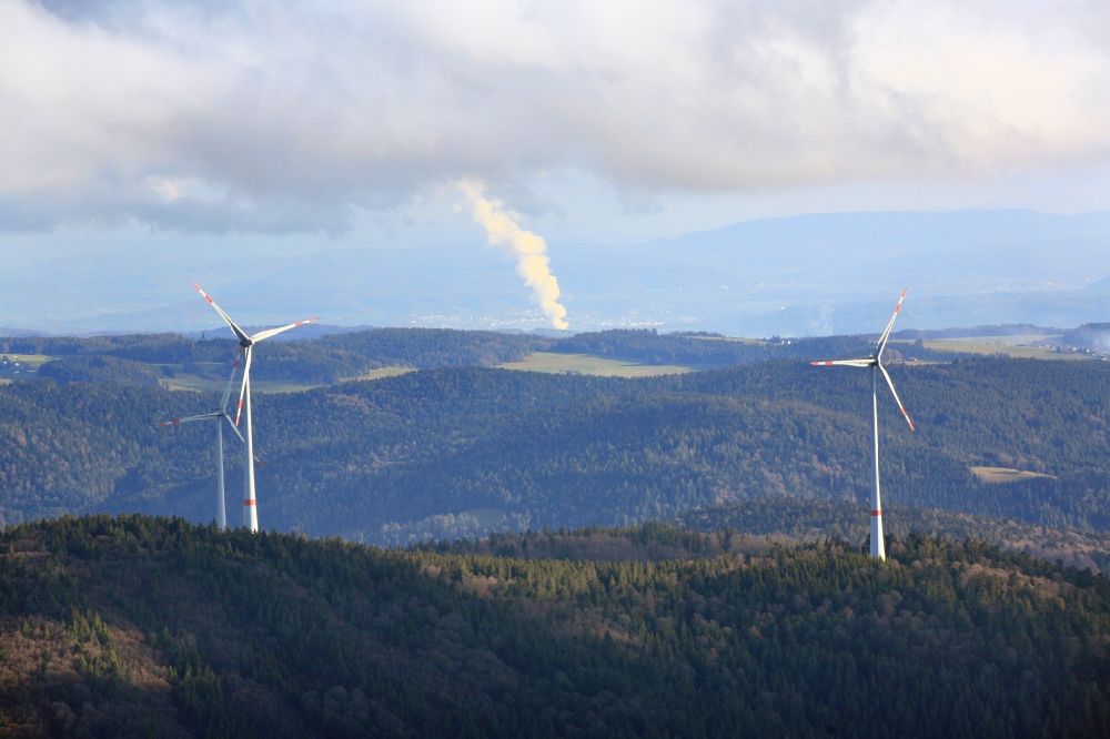 Aerial image Schopfheim - Wind turbines of the wind farm Rohrenkopf in the Black Forest in Gersbach in the state Baden-Wurttemberg, Germany. In the background the steam column of swiss nuclear power plant Leibstadt KKL. Symbolic image for the controversial debate of nuclear power versus renewable power