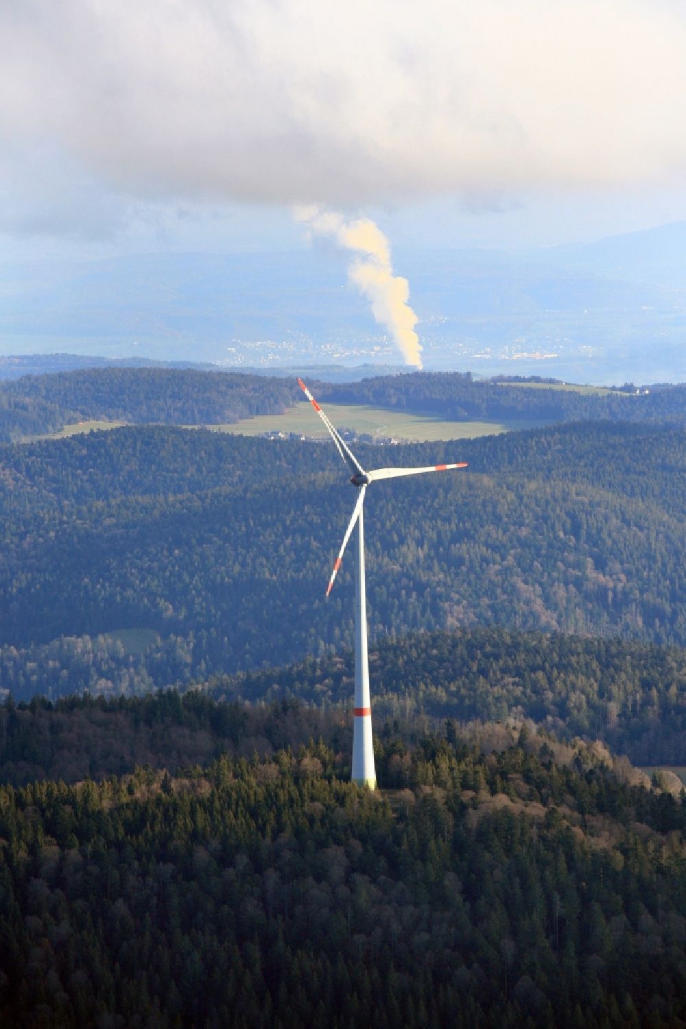Aerial photograph Schopfheim - Wind turbines of the wind farm Rohrenkopf in the Black Forest in Gersbach in the state Baden-Wurttemberg, Germany. In the background the steam column of swiss nuclear power plant Leibstadt KKL. Symbolic image for the controversial debate of nuclear power versus renewable power