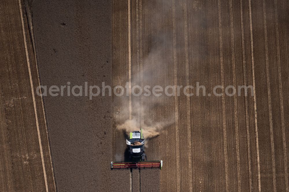 Aerial photograph Broitzem - Harvest use of heavy agricultural machinery - combine harvesters and harvesting vehicles on agricultural fields in Broitzem in the state Lower Saxony, Germany