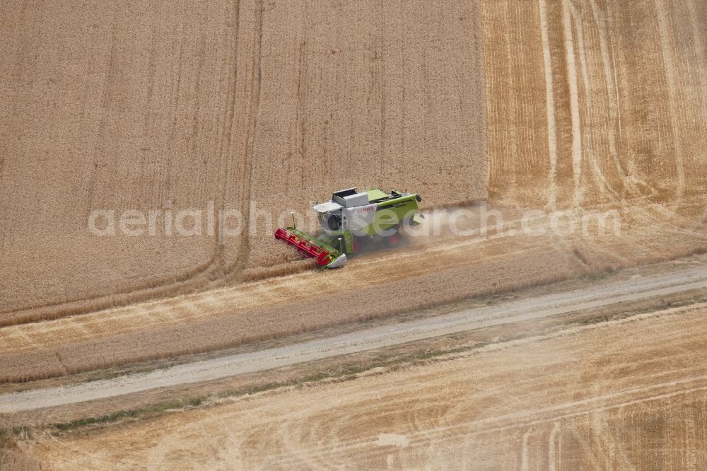 Aerial photograph Dransfeld - Harvest use of heavy agricultural machinery - combine harvesters and harvesting vehicles on agricultural fields in Dransfeld in the state Lower Saxony, Germany