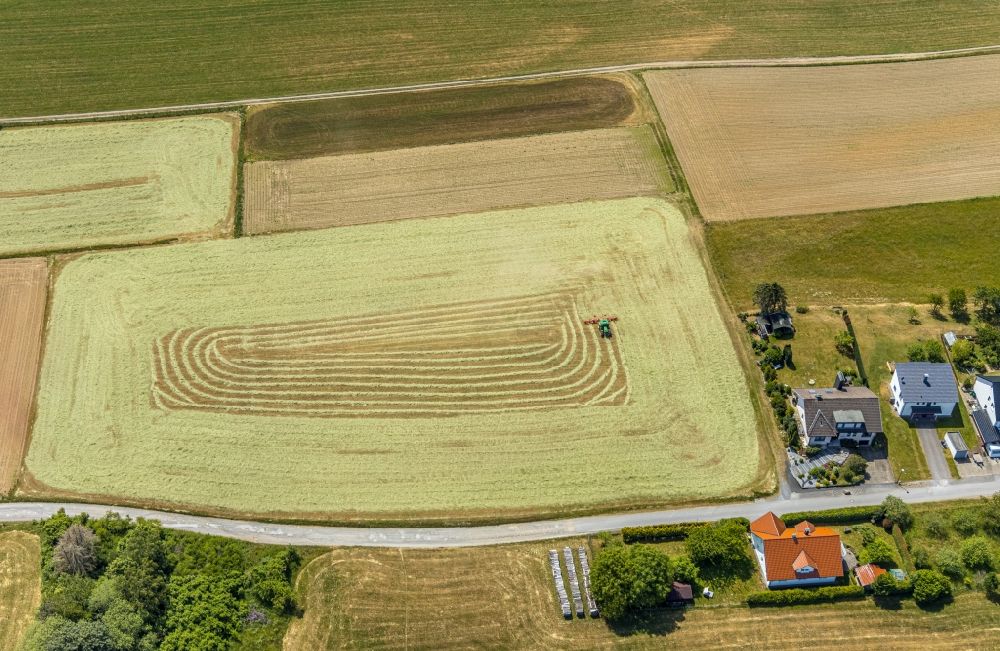 Aerial image Garbeck - Harvest use of heavy agricultural machinery - combine harvesters and harvesting vehicles on agricultural fields in Garbeck in the state North Rhine-Westphalia, Germany