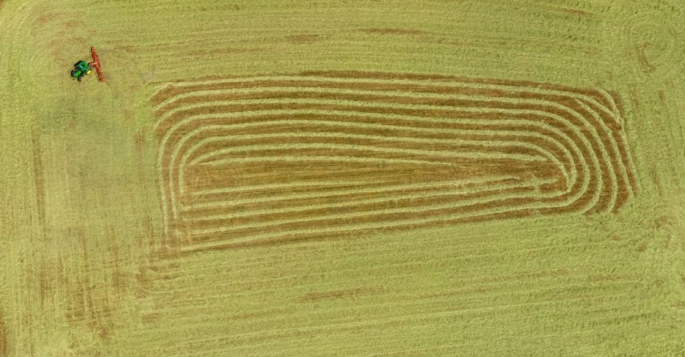 Aerial photograph Garbeck - Harvest use of heavy agricultural machinery - combine harvesters and harvesting vehicles on agricultural fields in Garbeck in the state North Rhine-Westphalia, Germany