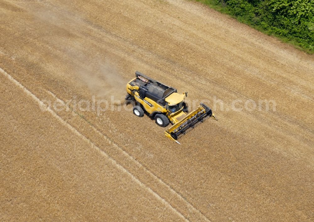 Aerial image Geismar - Harvest use of heavy agricultural machinery - combine harvesters and harvesting vehicles on agricultural fields in Geismar in the state Lower Saxony, Germany