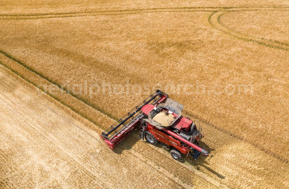 Aerial photograph Göhrenz - Harvest use of heavy agricultural machinery - combine harvesters and harvesting vehicles on agricultural fields in Goehrenz in the state Saxony, Germany