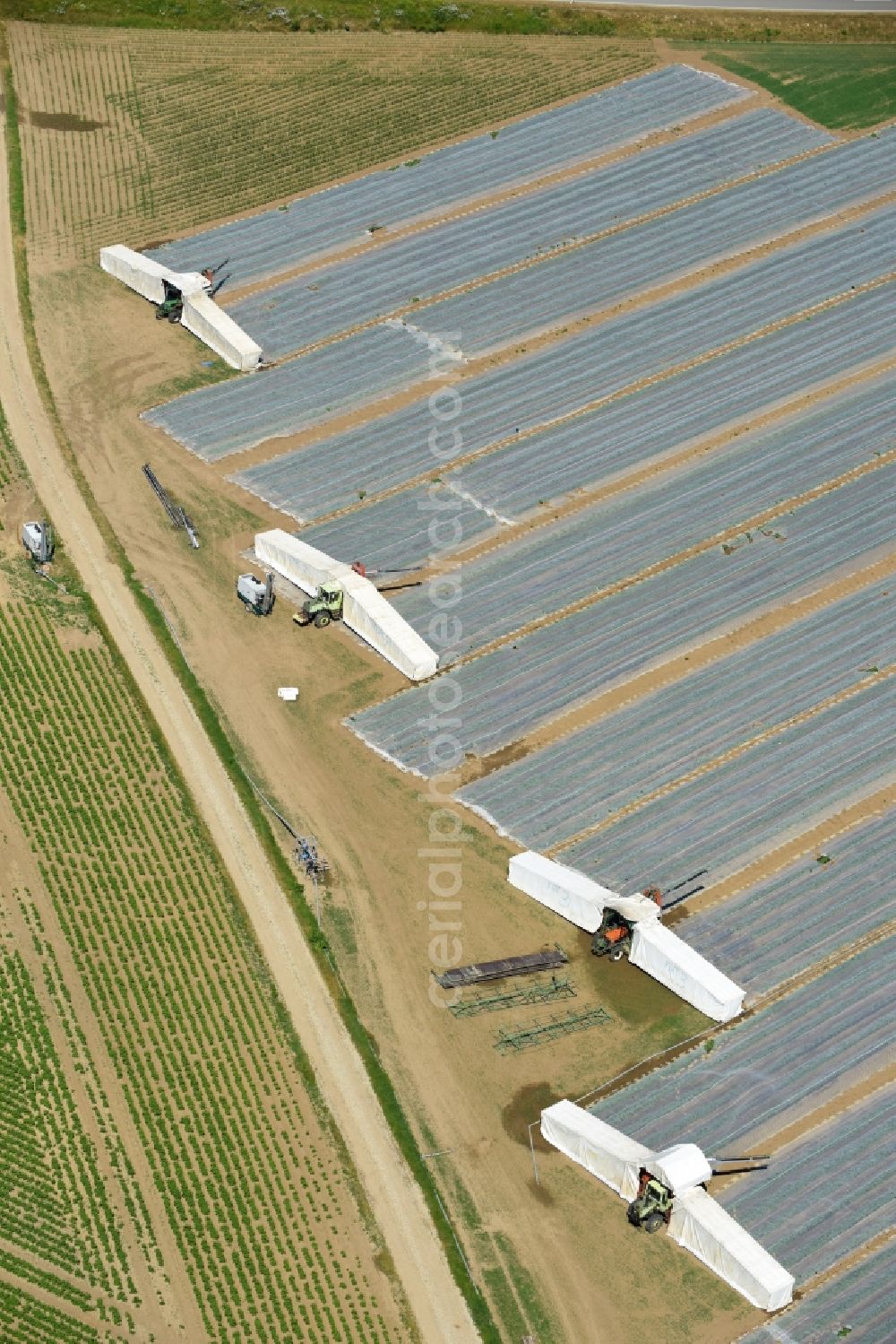 Aerial image Moos - Harvest use of heavy agricultural machinery and harvesting vehicles on agricultural fields in Moos in the state Bavaria, Germany