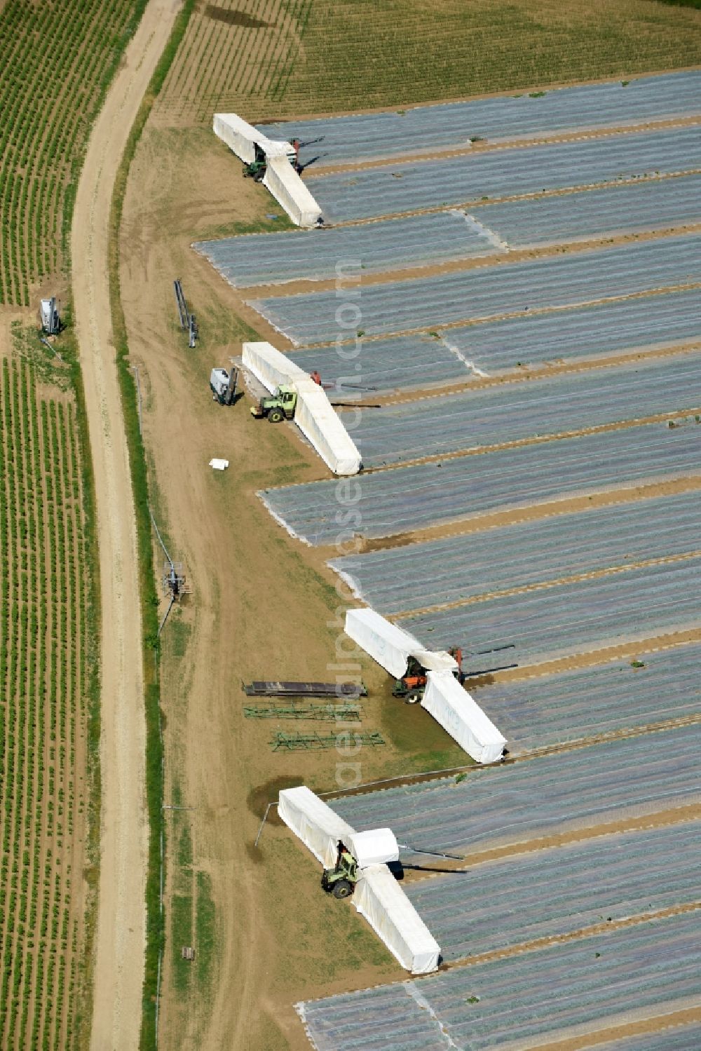 Aerial photograph Moos - Harvest use of heavy agricultural machinery and harvesting vehicles on agricultural fields in Moos in the state Bavaria, Germany