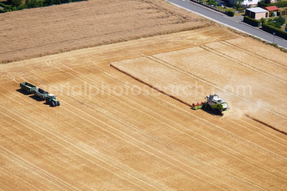 Aerial photograph Neu-Eichenberg - Harvest use of heavy agricultural machinery - combine harvesters and harvesting vehicles on agricultural fields in Neu-Eichenberg in the state Hesse, Germany