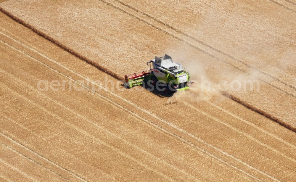 Neu-Eichenberg from above - Harvest use of heavy agricultural machinery - combine harvesters and harvesting vehicles on agricultural fields in Neu-Eichenberg in the state Hesse, Germany