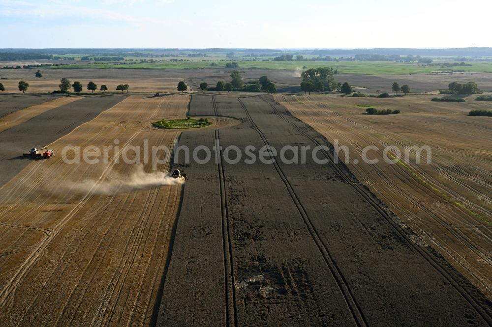 Aerial photograph Schapow - Harvest use of heavy agricultural machinery - combine harvesters and harvesting vehicles on agricultural fields in Schapow Uckermark in the state Brandenburg, Germany