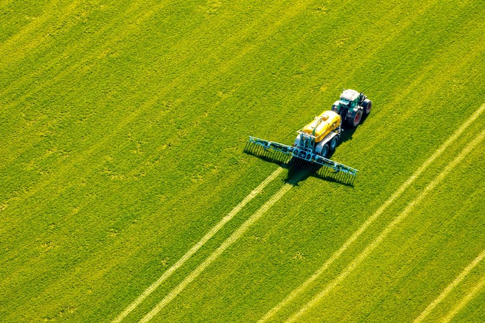 Aerial photograph Sundern (Sauerland) - Harvest use of heavy agricultural machinery - combine harvesters and harvesting vehicles on agricultural fields in Sundern (Sauerland) in the state North Rhine-Westphalia, Germany