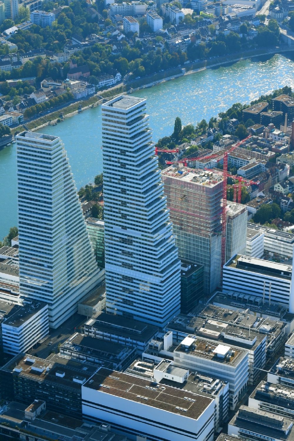 Aerial photograph Basel - Extension construction sites on the premises of the pharmaceutical company Roche with the cityscape-defining high-rise buildings in Basel in Switzerland