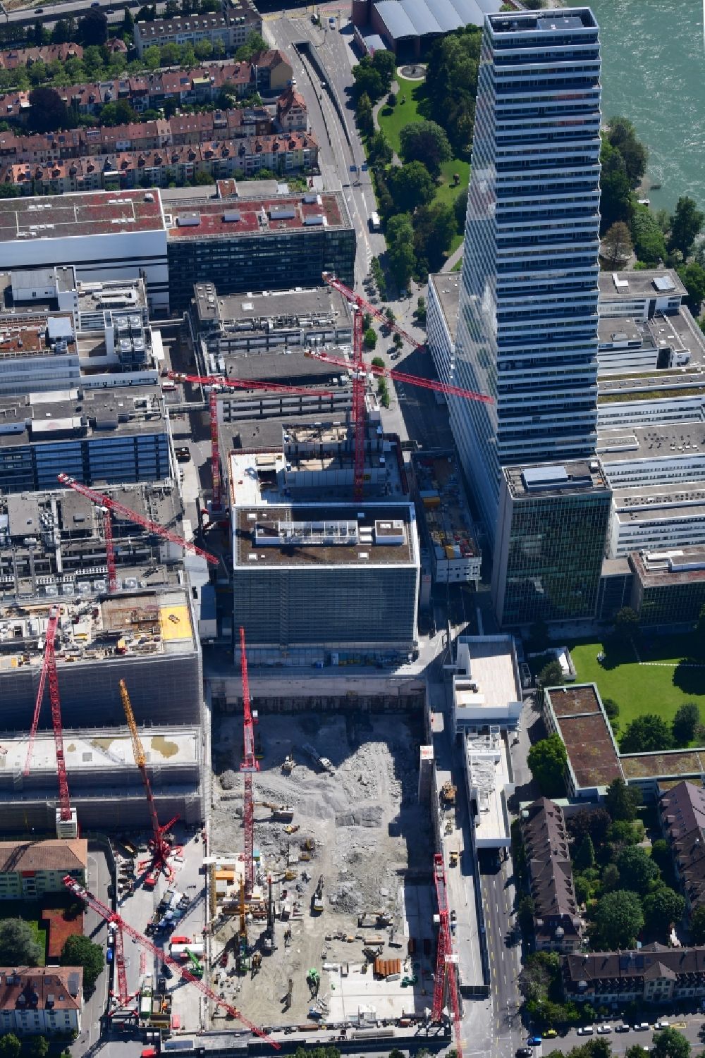 Aerial image Basel - Extension construction sites on the premises and premises of the pharmaceutical company Roche with the cityscape-defining high-rise in Basel in Switzerland