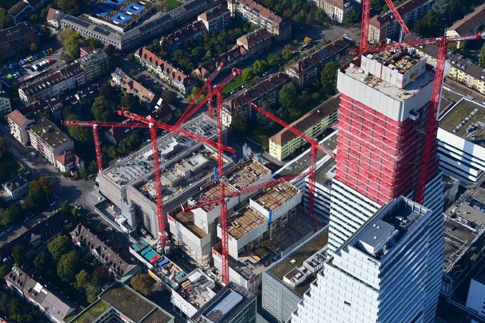 Aerial image Basel - Extension construction sites on the premises of the pharmaceutical company Roche with the cityscape-defining high-rise building in Basel in Switzerland. Construction works for the second tower are visible