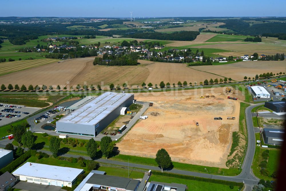Treuen from the bird's eye view: Extension - new building - construction site on the factory premises of EMW Treuen GmbH on street Herlasgruener Strasse - Am Wasserturm in the district Hartmannsgruen in Treuen in the state Saxony, Germany