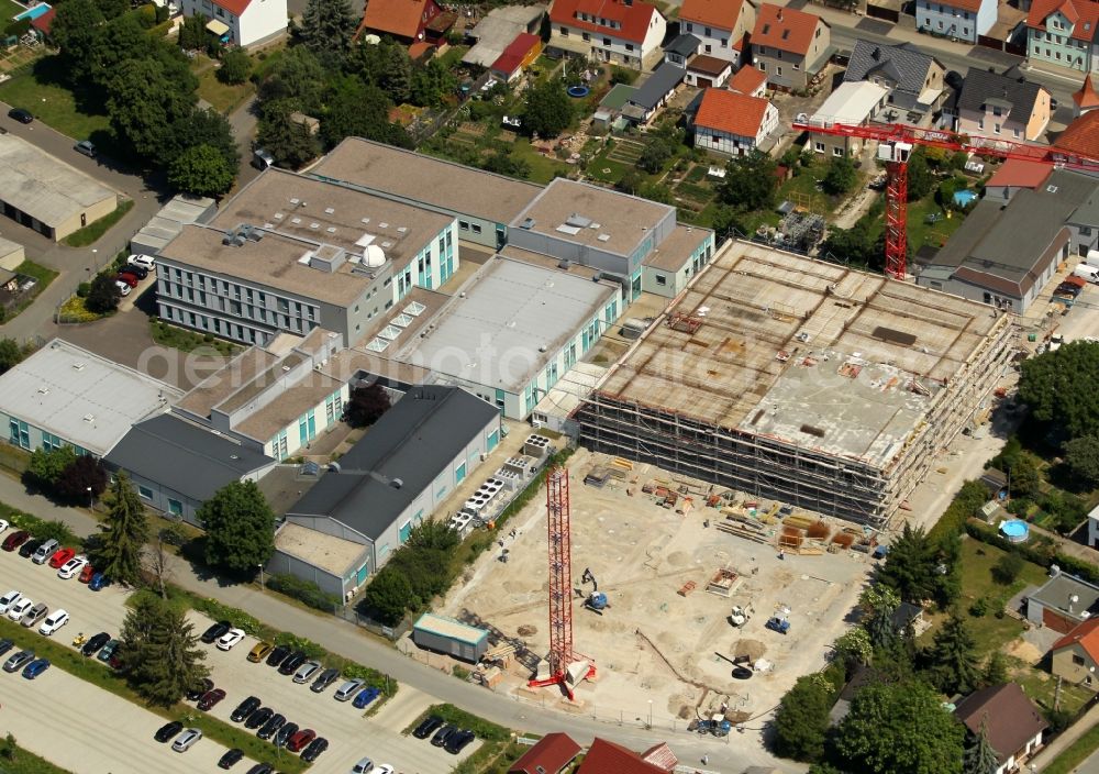 Mellingen from the bird's eye view: Extension - new building - construction site on the factory premises LAYERTEC GmbH on Ernst-Abbe-Weg in Mellingen in the state Thuringia, Germany