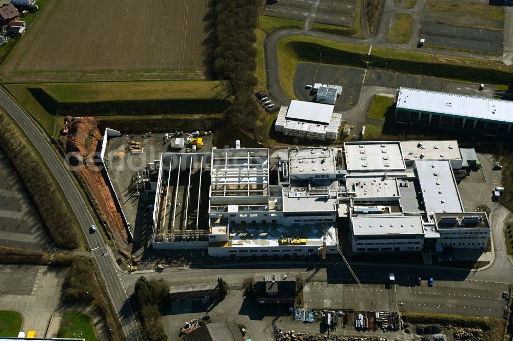 Melsungen from above - Extension - new building - construction site on the factory premises of Solupharm Pharmazeutische Erzeugnisse GmbH on Industriestrasse in the district Adelshausen in Melsungen in the state Hesse, Germany