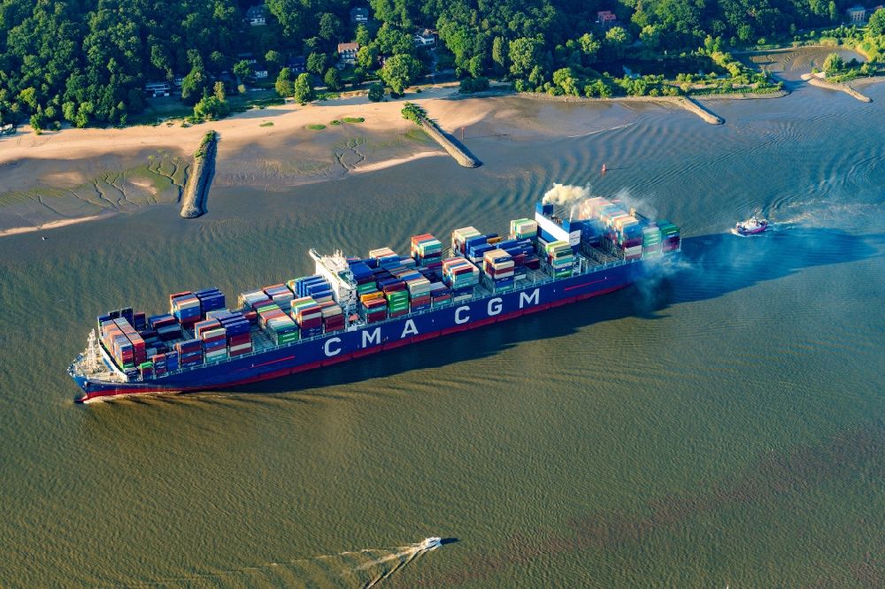 Hamburg from the bird's eye view: Sailing container ship CMA CGM Alexander von Humboldt in operation on elbe river in the district Finkenwerder in Hamburg, Germany