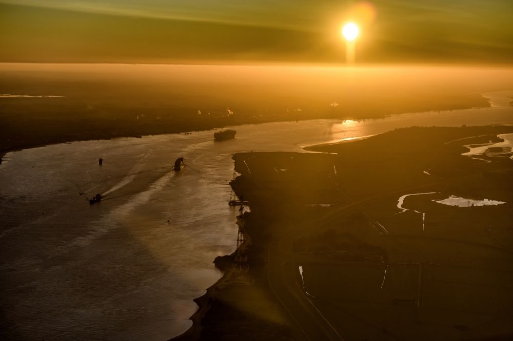 Hetlingen from above - Voyage of a container ship on the Elbe in the sunset in Drochtersen in the state Lower Saxony, Germany