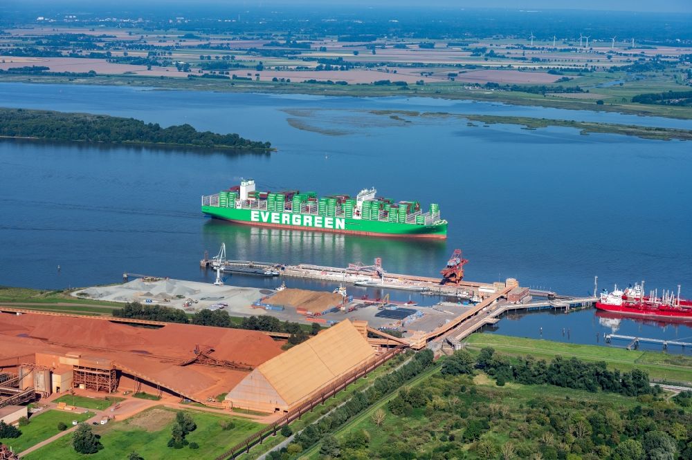 Aerial photograph Stade - Sailing container ship Ever Ace at the Elbe river in Hamburg, Germany