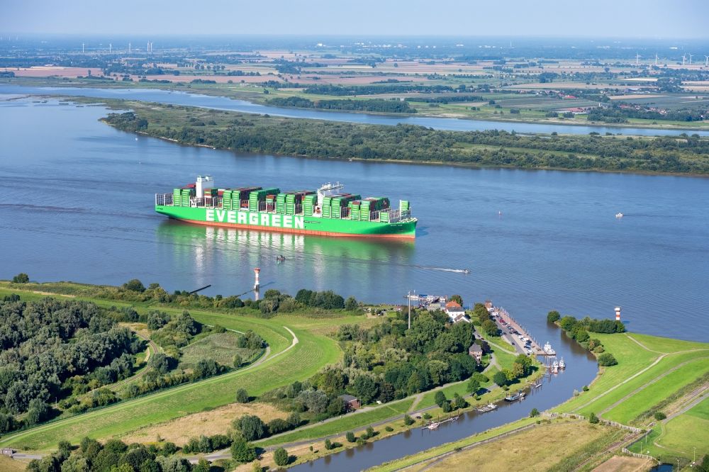 Aerial image Stade - Sailing container ship Ever Ace at the Elbe river in Hamburg, Germany