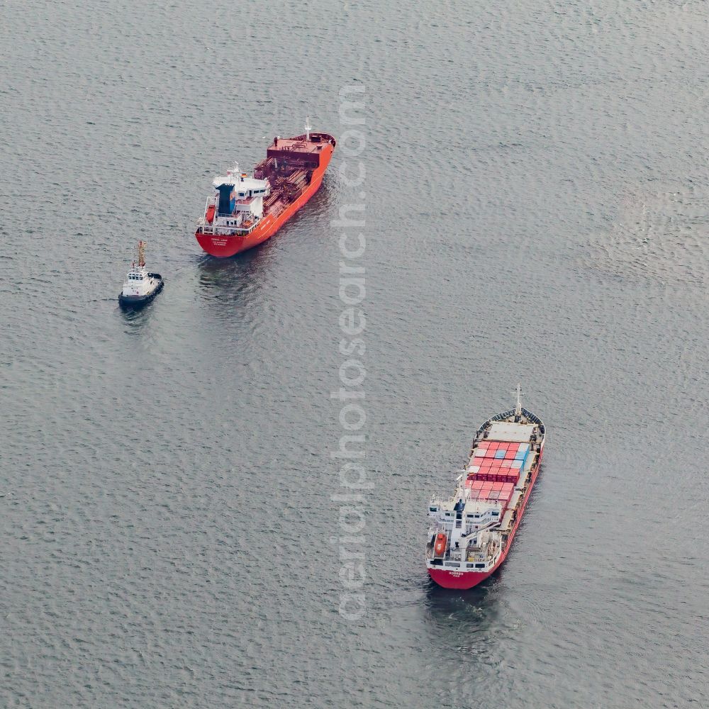 Aerial photograph Kiel - Slow travel of a container ship on the Kiel Fjord in front of the Holtenauer Reede in Kiel in the state Schleswig-Holstein, Germany. The cargo ship HJOeRDIS ( IMO 9126235 ) and the liquid gas LPG tanker CORAL LEAF ( IMO 9404625 ) with the assistance tug PARAT ( IMO 8128212 ) in waiting position in Holtenau