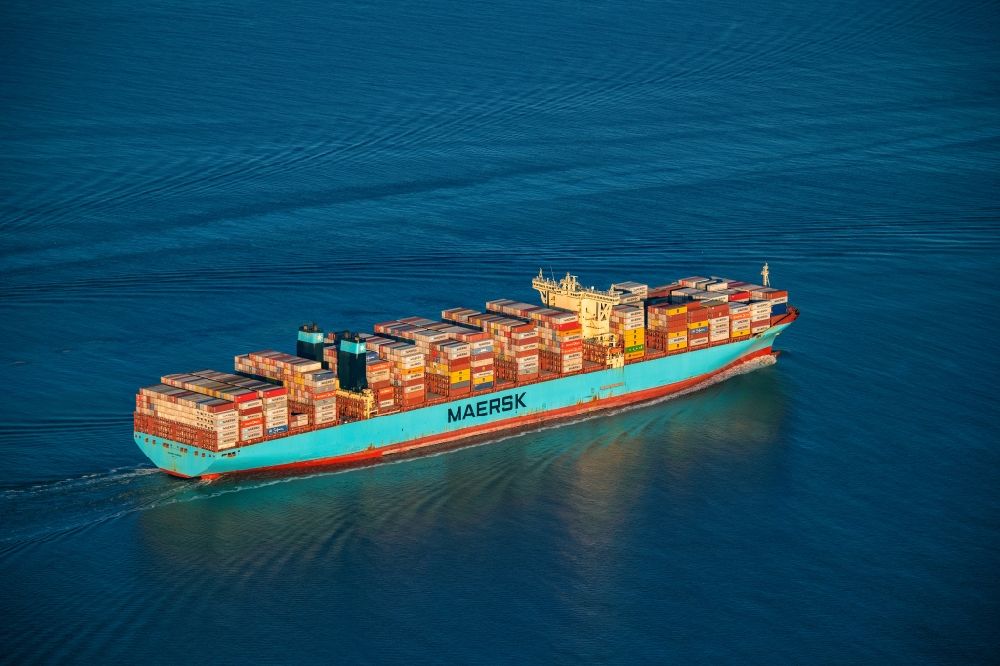 Aerial image Butjadingen - Moving container ship Maribor Maersk in the Weser estuary in Butjadingen in the state Lower Saxony, Germany