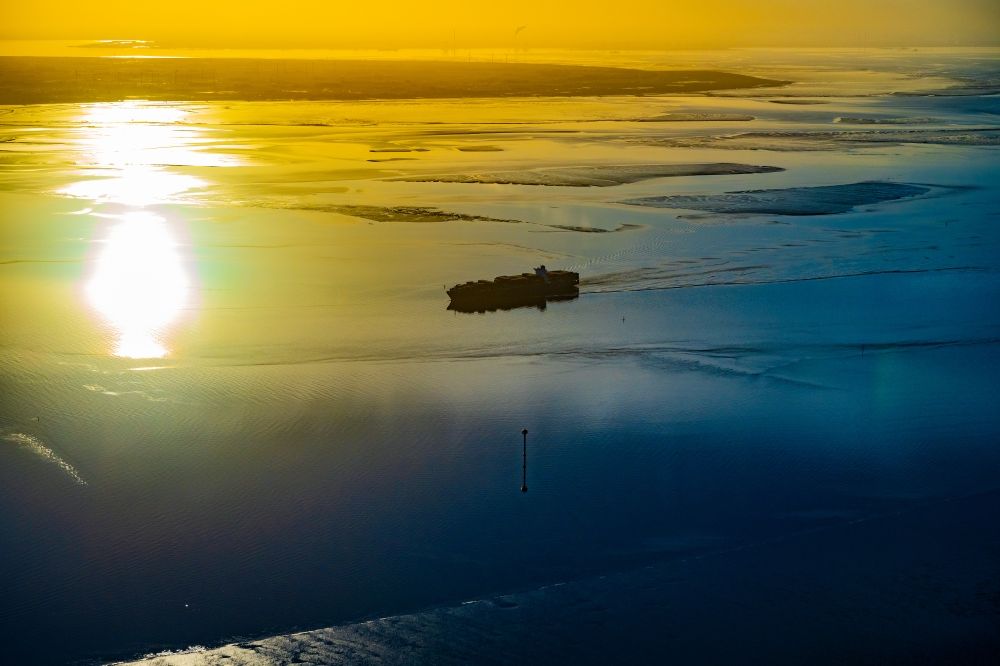 Aerial image Butjadingen - Moving container ship Maribor Maersk in the sunset in the Weser estuary in Butjadingen in the state Lower Saxony, Germany