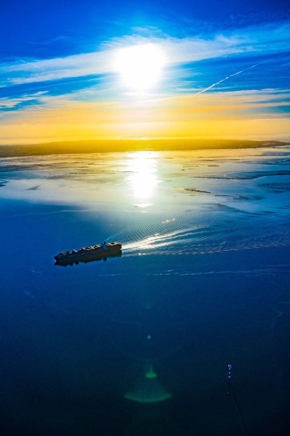 Aerial photograph Butjadingen - Moving container ship Maribor Maersk in the sunset in the Weser estuary in Butjadingen in the state Lower Saxony, Germany