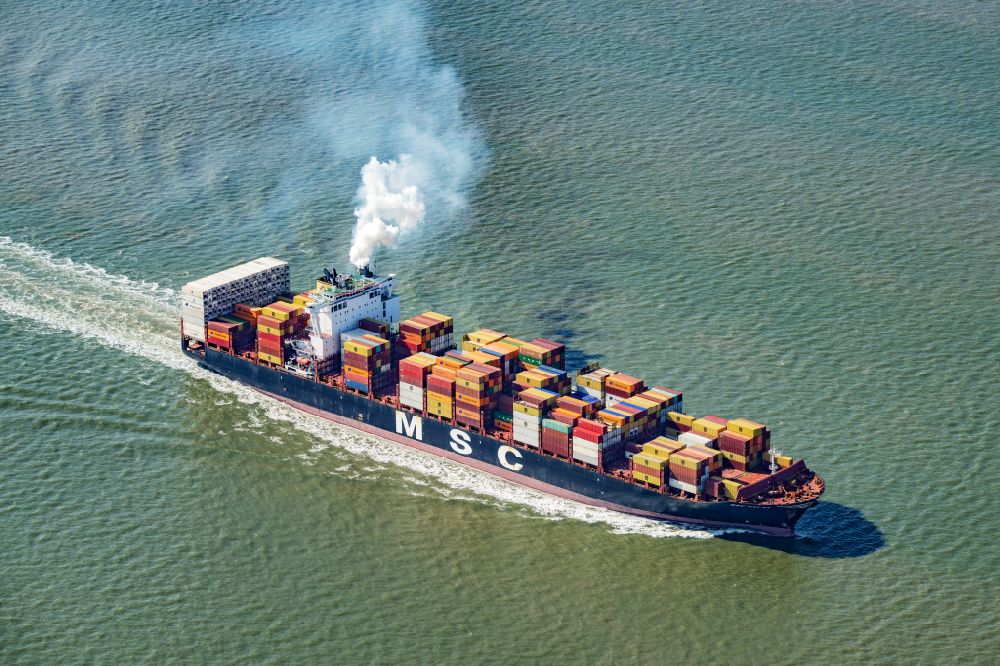 Aerial photograph Butjadingen - Journey of a container ship MSC PALAK ( IMO: 9735206, MMSI: 255805865 ) on the North Sea in Butjadingen in the state of Lower Saxony, Germany