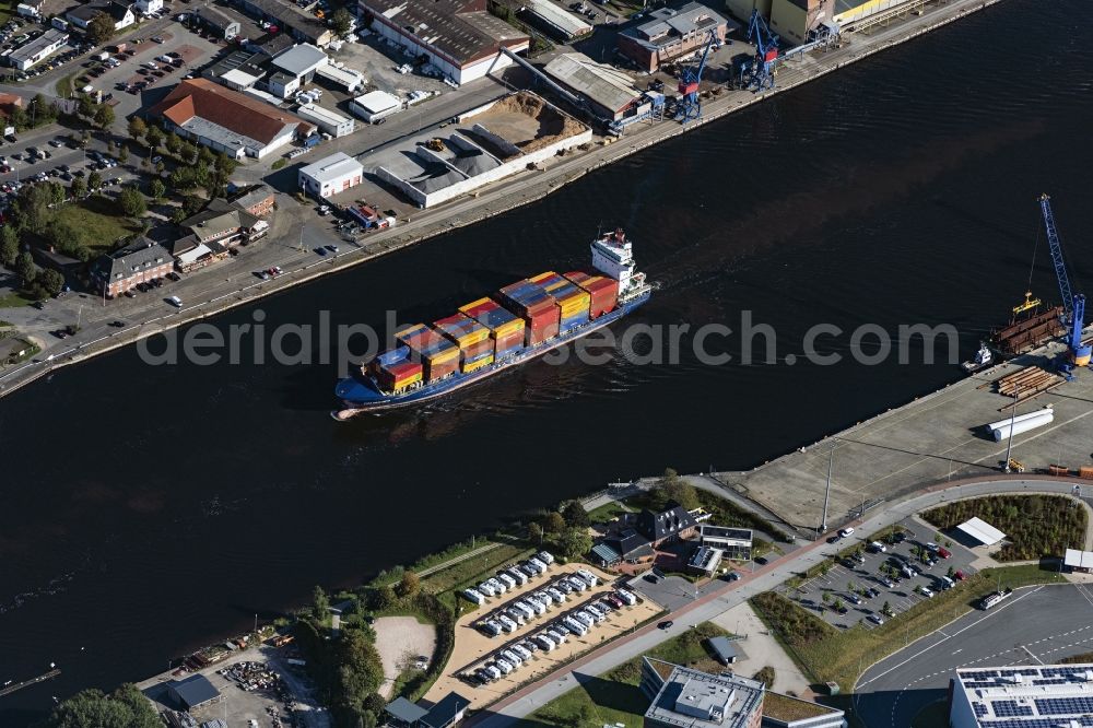 Rendsburg from above - Sailing container ship on Nord-Ostsee-Kanal in Rendsburg in the state Schleswig-Holstein, Germany