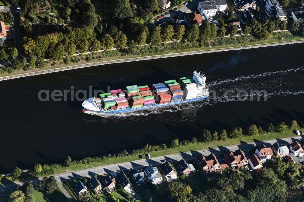 Rendsburg from above - Sailing container ship on Nord-Ostsee-Kanal in Rendsburg in the state Schleswig-Holstein, Germany