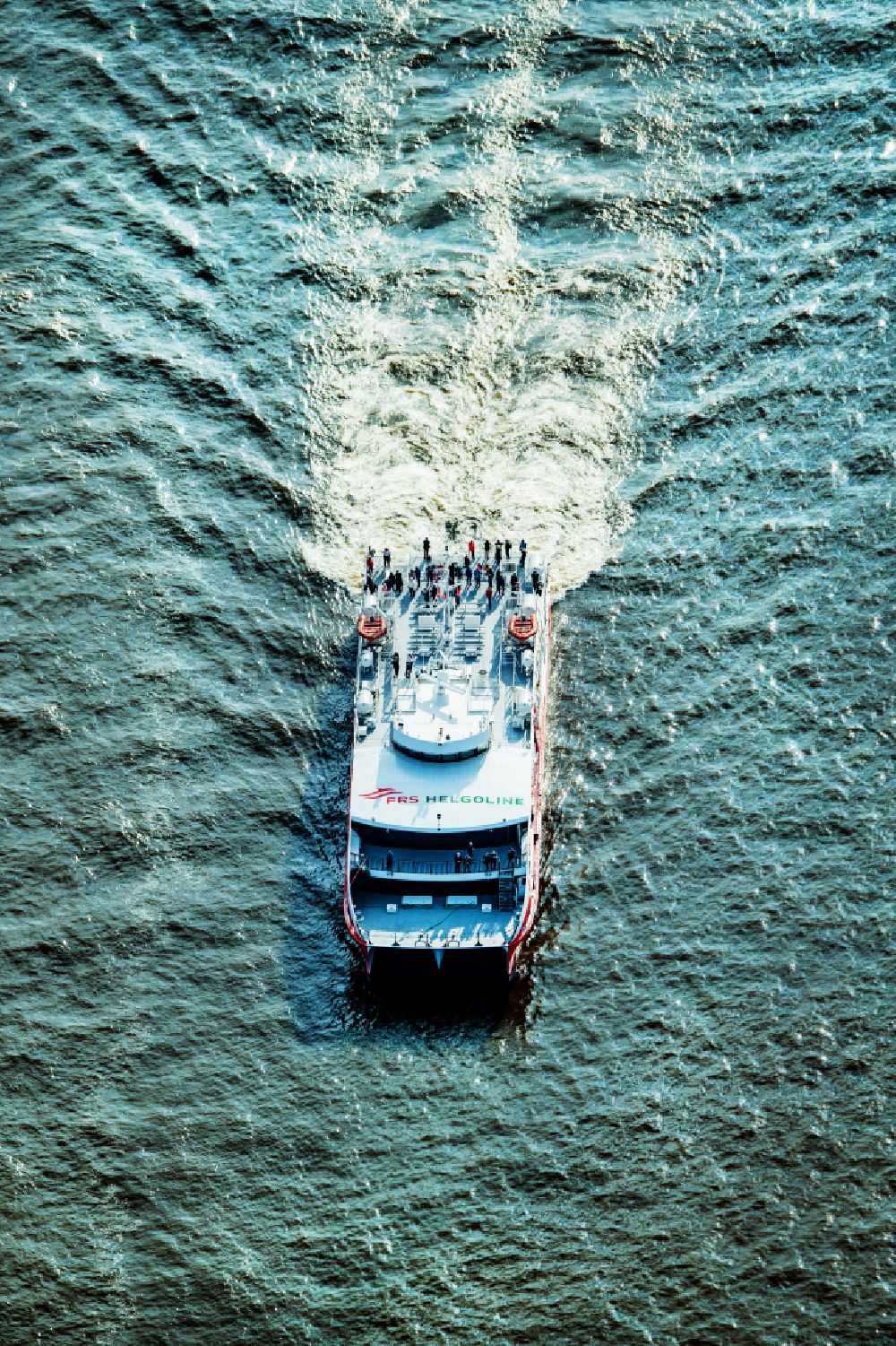 Hamburg from above - Travel of a ferry ship Katamaran Halunder Jet der FRS Reederei in Hamburg in front of the Landungsbruecken in the state Lower Saxony, Germany